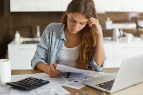 woman looking at bills